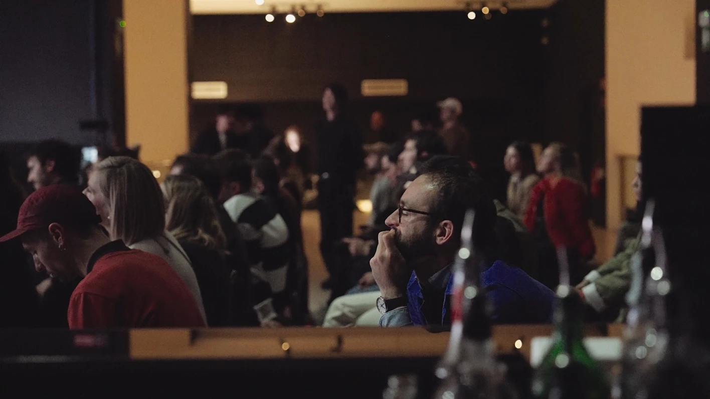 Visitors having a conversation in an indoor space.