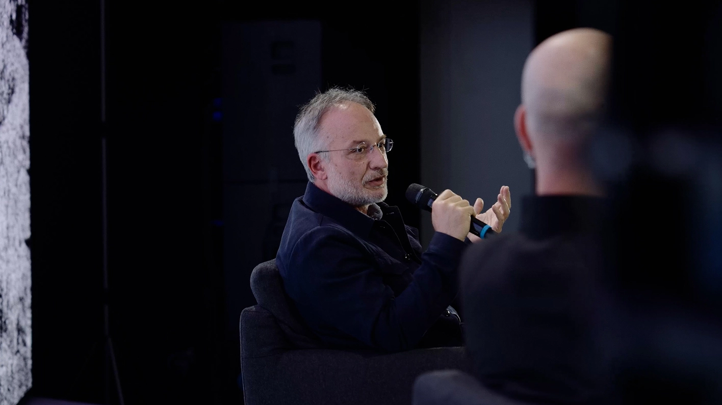 Kia Vice President Karim Habib speaking with a microphone.