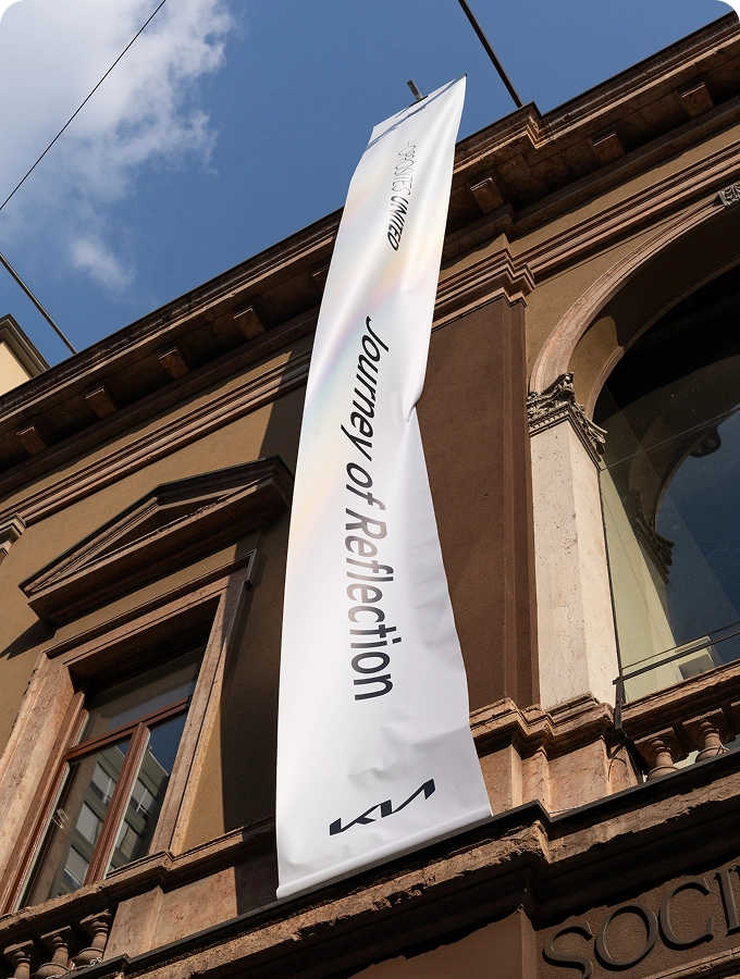 Exterior of Museo della Permanente hosting the Journey of Reflection exhibition with an OPPOSITES UNITED banner.