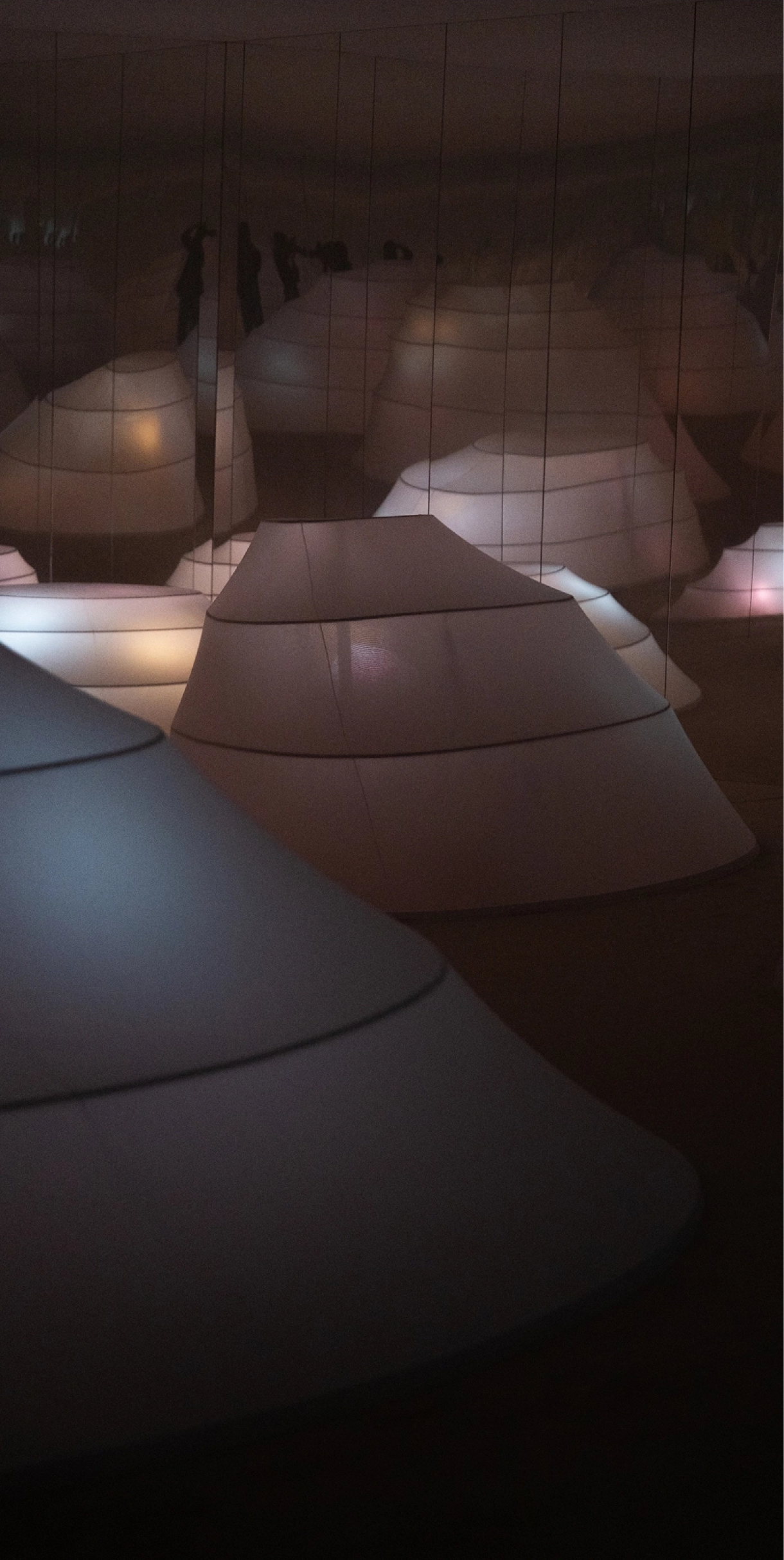 Curved hill-like structures and illuminated exhibition space in the Creative Risk-Takers Dare section.