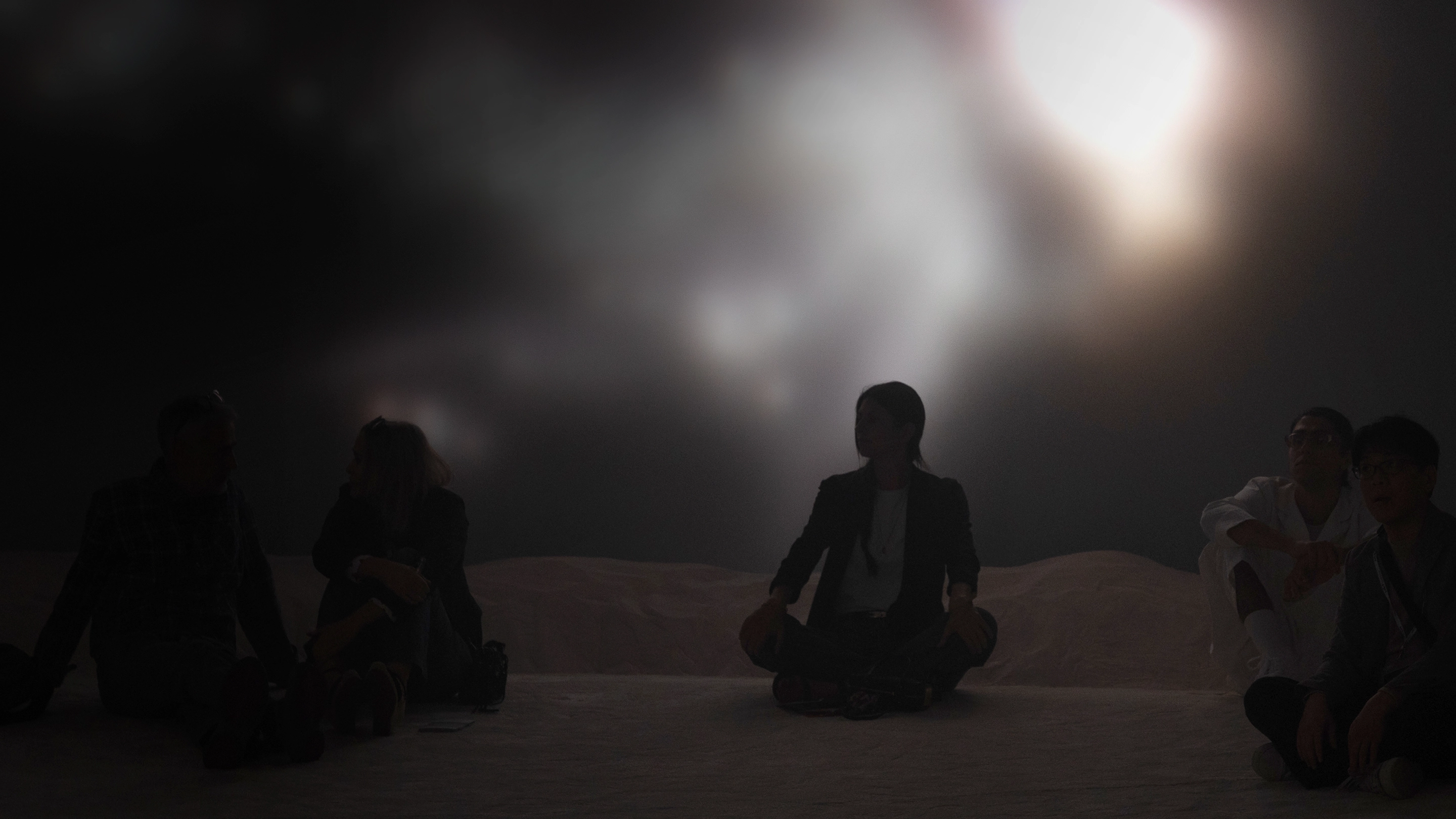 Visitors seated in front of a circular installation in the Relentless Innovators Muse section