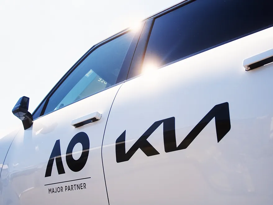 Side view of a Kia vehicle with AO Major Partner branding.