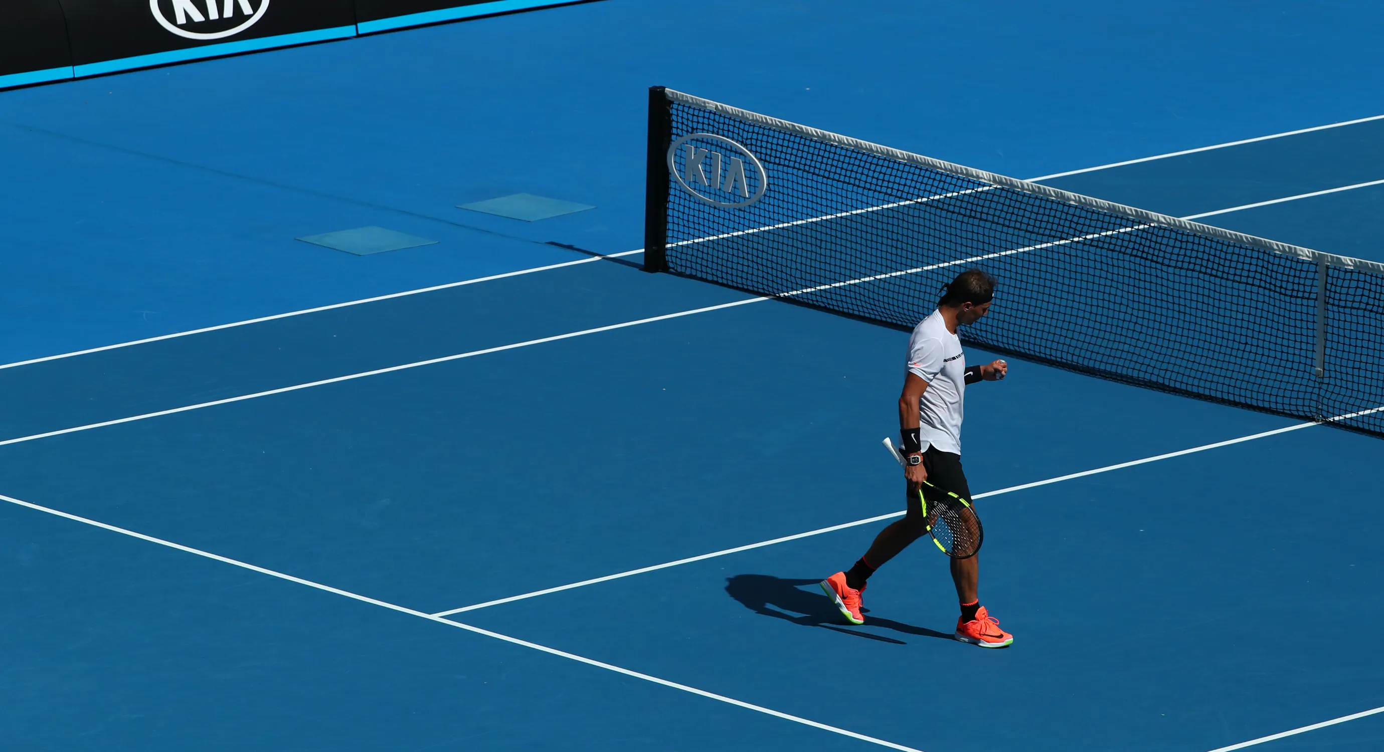 A tennis player preparing on the court.