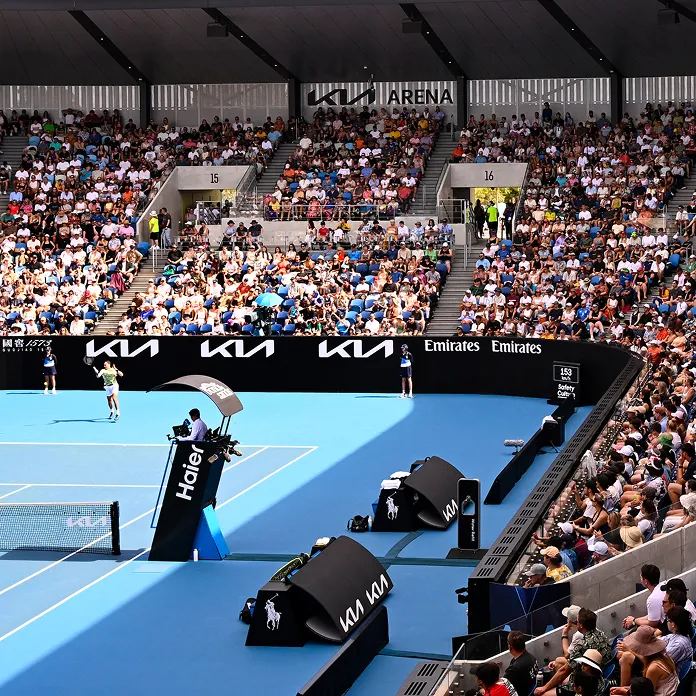 AO tennis stadium view with spectator stands and Kia advertising boards