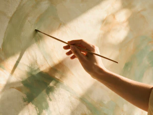 Close-up of a hand painting abstract colors with a brush