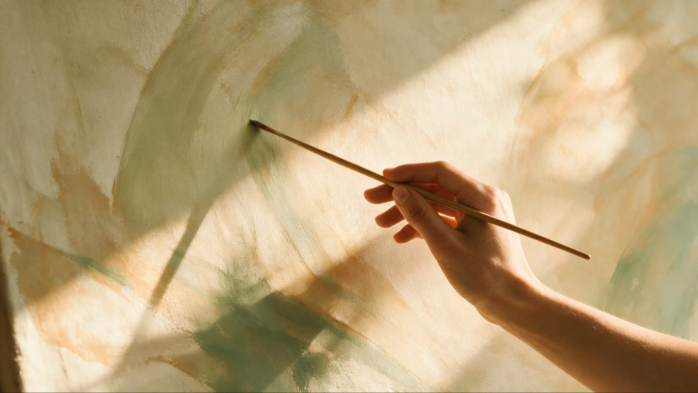 Close-up of a hand painting abstract colors with a brush
