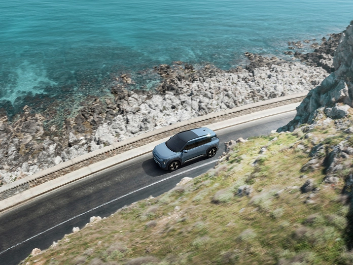 Image of the Kia EV3 driving along a coastal road, winner of the 2024 TopGear.com Crossover of the Year