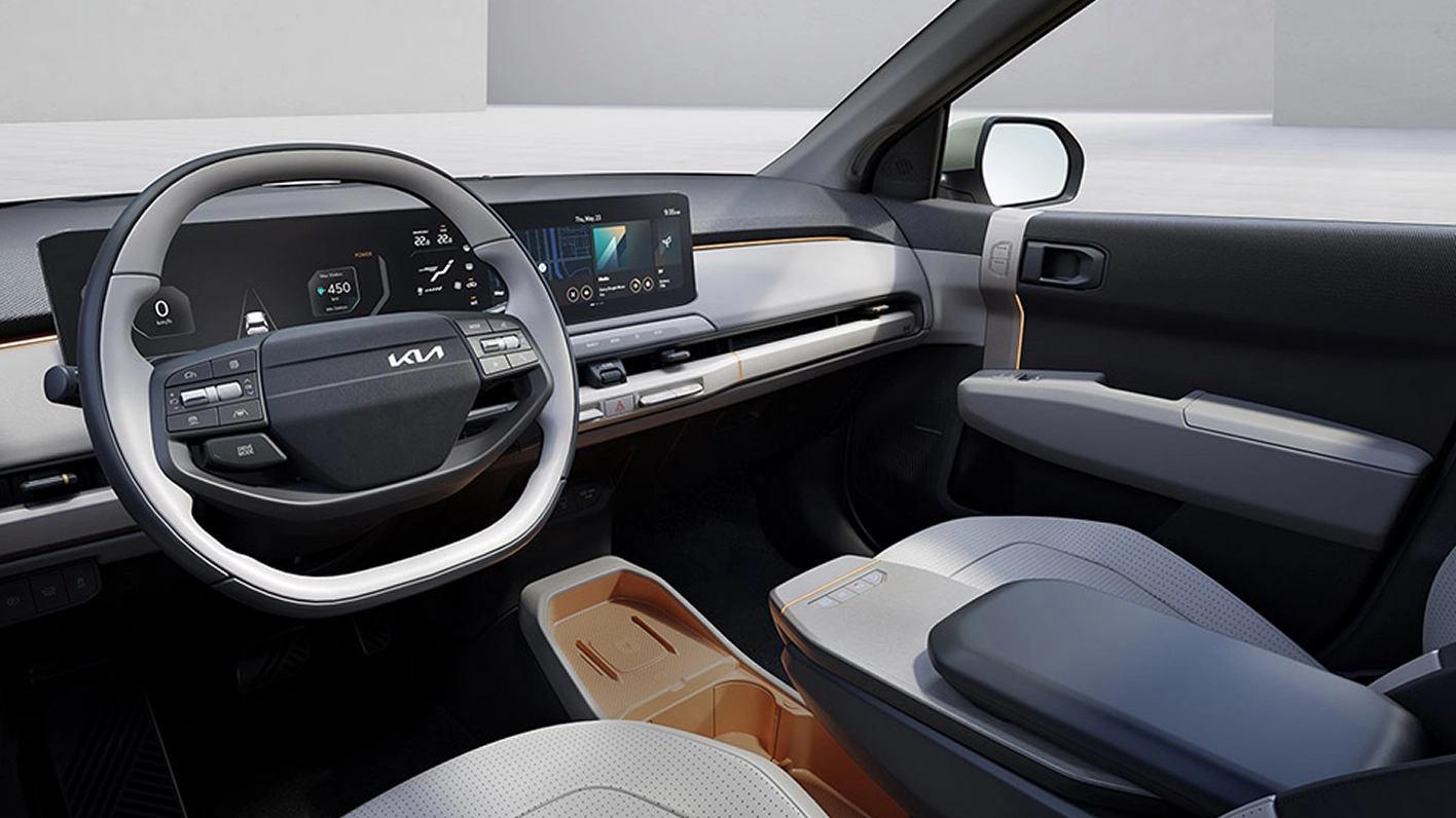 Interior image of the Kia EV3 driver’s seat featuring the panoramic display, winner of the 2025 Red Dot Design Award Best of the Best