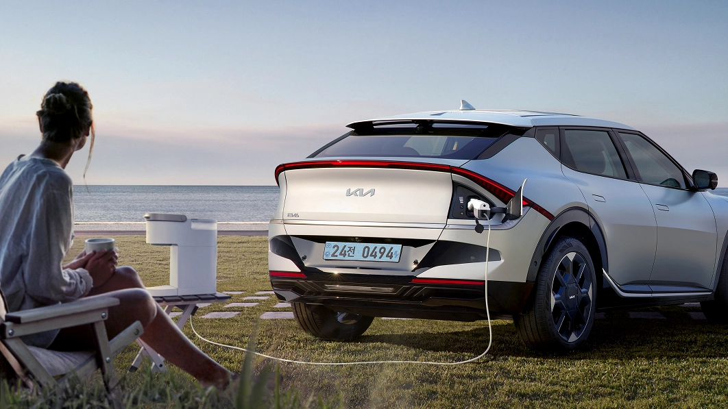 Kia EV6 using the V2L function by the seaside