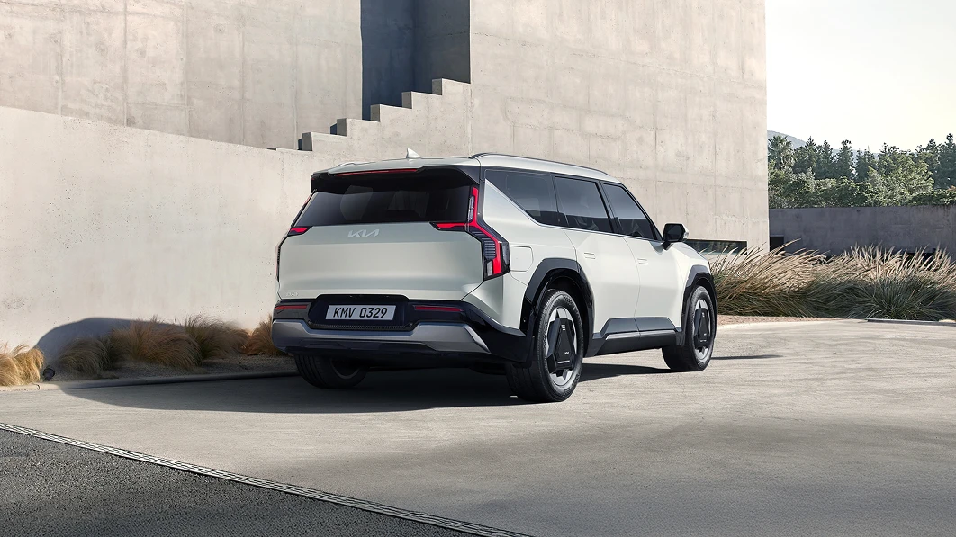 Rear driving image of Kia EV9 with North American Car of the Year award logo