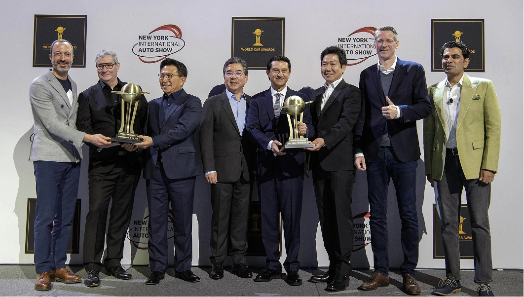 Scene of the Kia EV9 receiving both the 2024 World Car of the Year and World Electric Vehicle awards