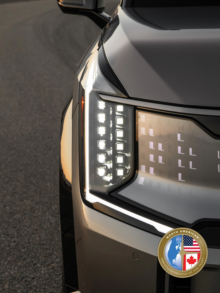 Close-up image of the Kia EV9 front headlamp with digital pattern lighting
