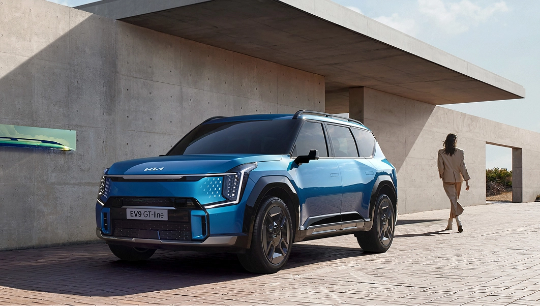 Side view of the Kia EV9 GT-line parked in front of a building