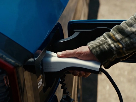 Close-up of the Kia EV9 using the V2L (Vehicle-to-Load) function