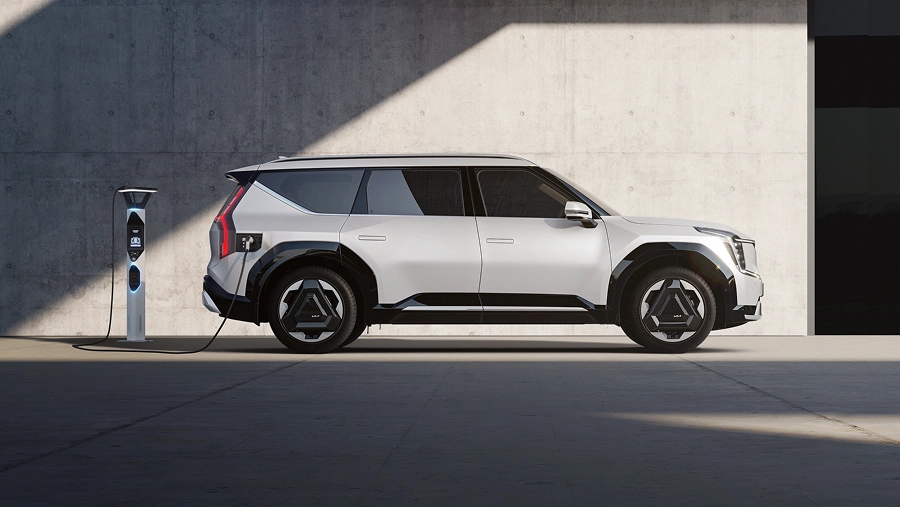 Side view of the Kia EV9 charging at an EV charging station