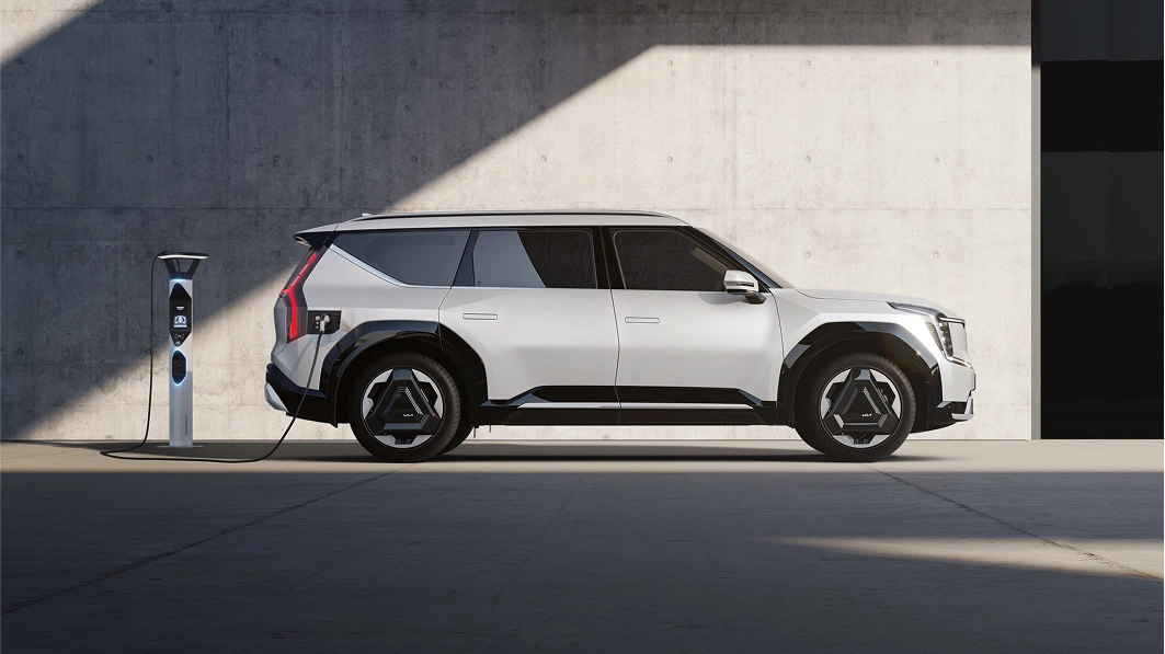 Side view of the Kia EV9 charging at an EV charging station