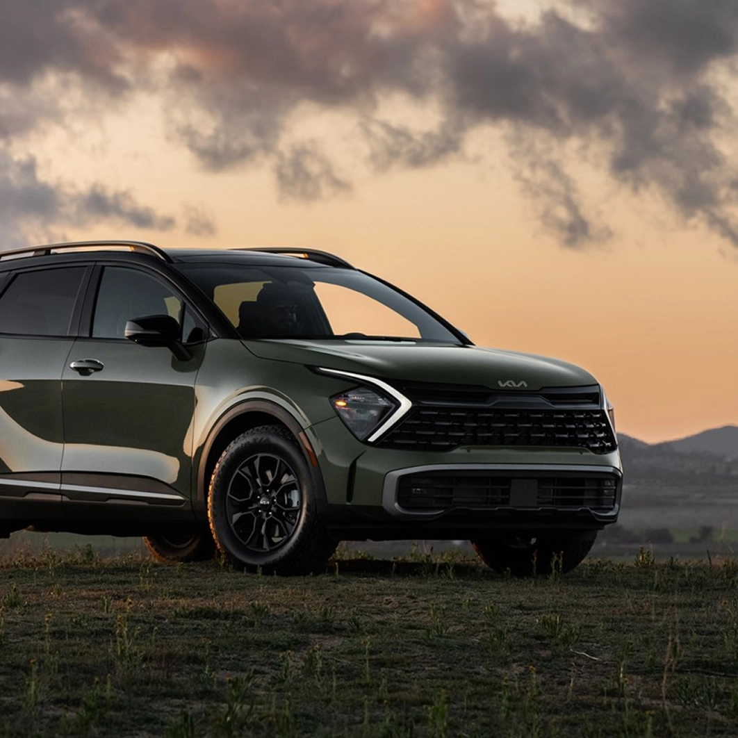 Kia Sportage parked against a sunset backdrop