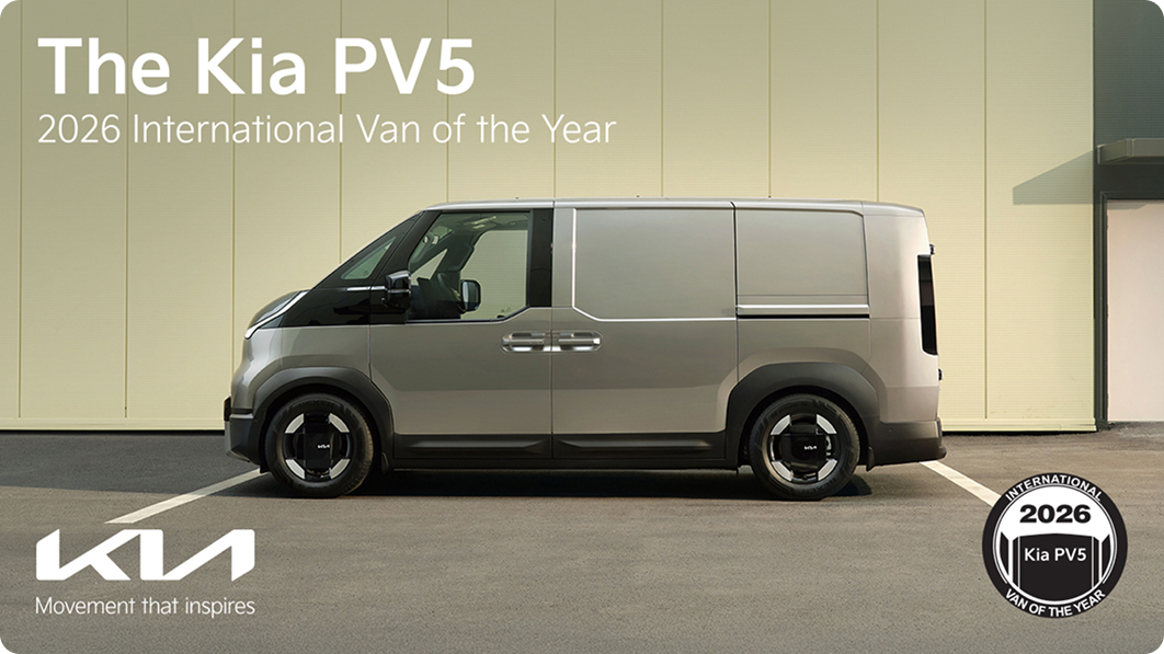 Side exterior view of the Kia PV5 with “The Kia PV5” and 2026 International Van of the Year award messaging