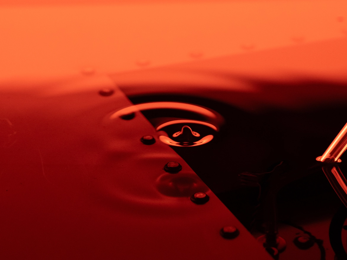 Reflections and ripples on a red surface in A.A. Murakami's 'The Cave'.