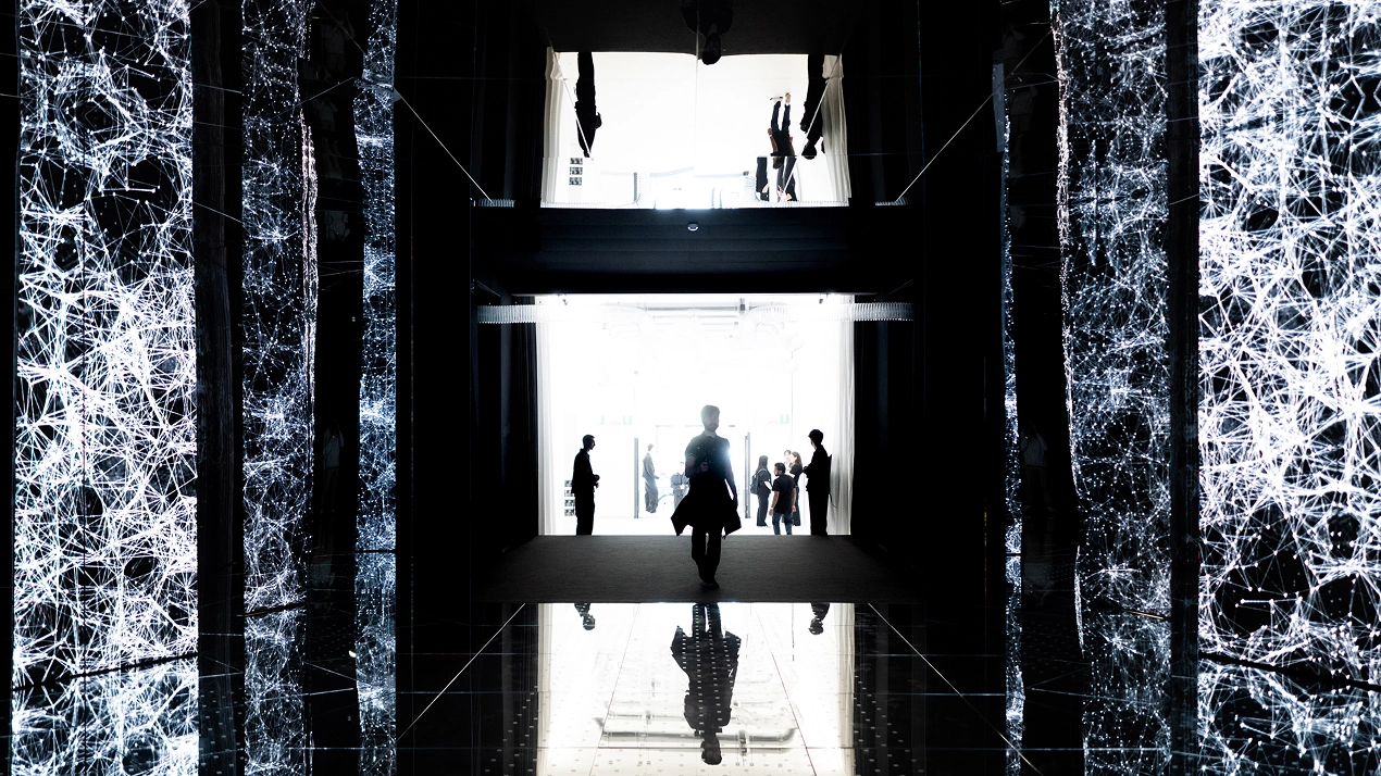 Corridor with the media installation 'Passage of Footsteps' displaying abstract patterns