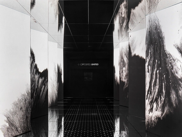 Entrance media wall in black and white with a mirrored floor of 'Passage of Footsteps'.