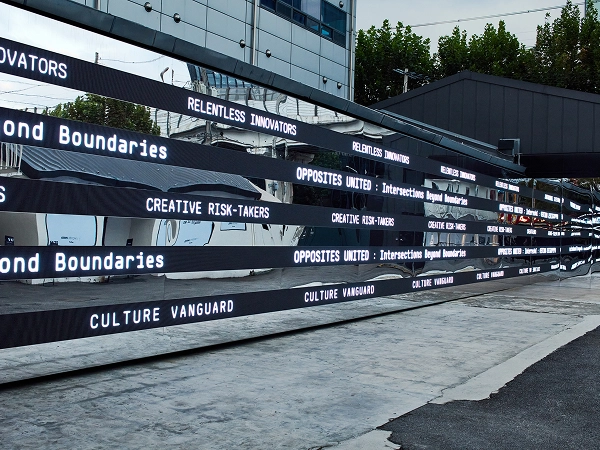 Media strips along the building exterior displaying repeated 'OPPOSITES UNITED' typography at the Seongsu solo exhibition in Seoul.
