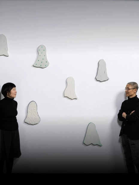 Two people talking in an exhibition space