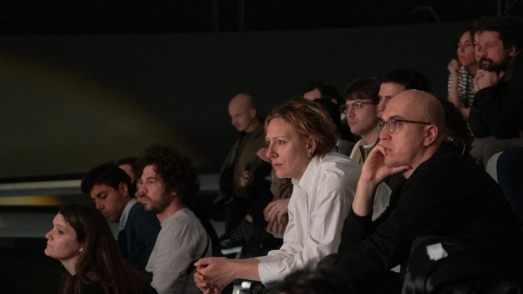 Audience seated and watching the stage.
