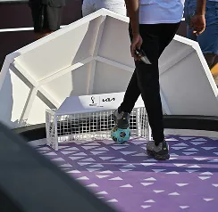 Visitor participating in a mini football game at a Kia experience booth