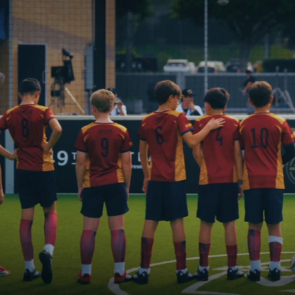 Rear view of FIFA World Cup 2026 OMBC children facing the pitch after being selected through the OMBC Cup