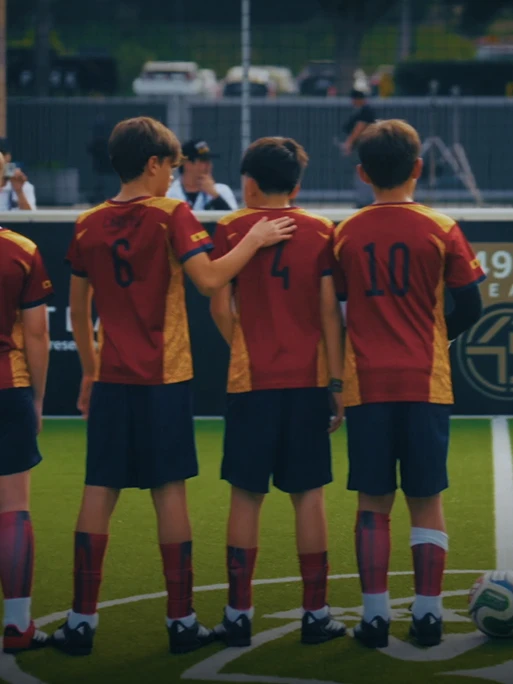 Rear view of FIFA World Cup 2026 OMBC children facing the pitch after being selected through the OMBC Cup