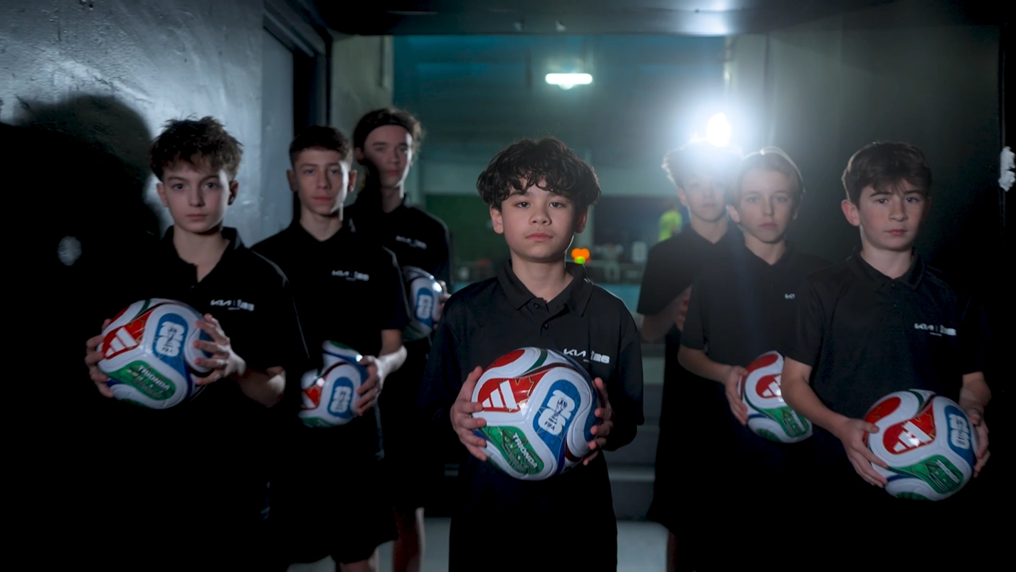 Group of OMBC participants holding official match balls