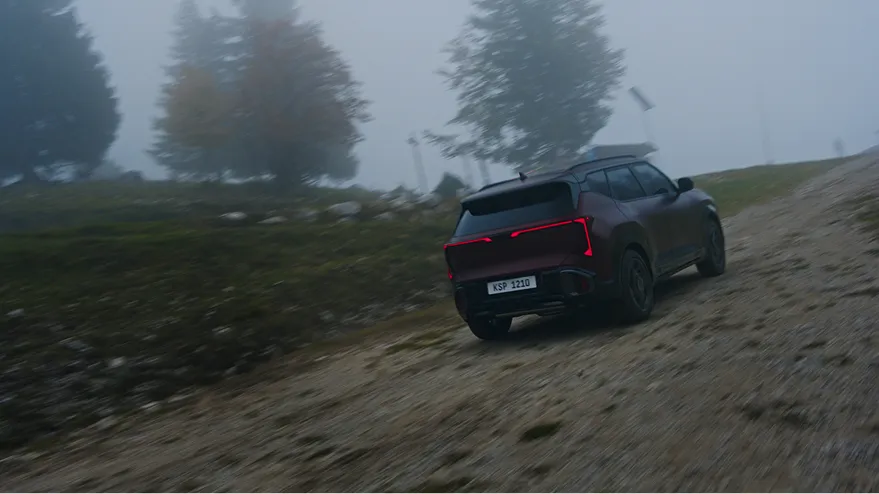The Seltos driving up a foggy, unpaved hill with Terrain Mode engaged.