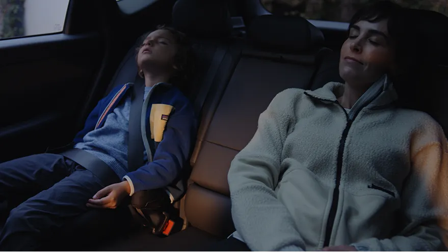 A family relaxing comfortably in the Rear Reclining Seats.