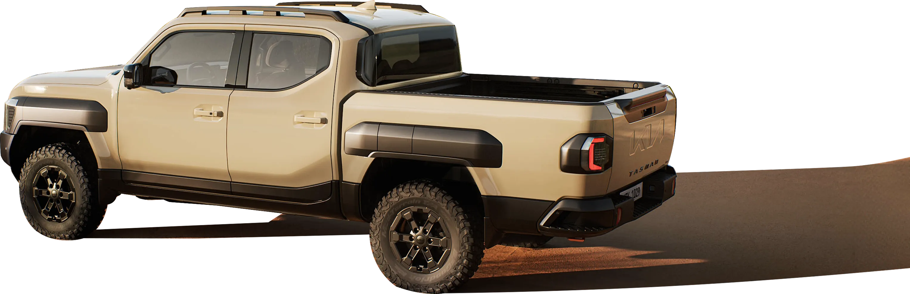 사막 위를 주행 중인 기아 타스만 픽업트럭의 측면 모습