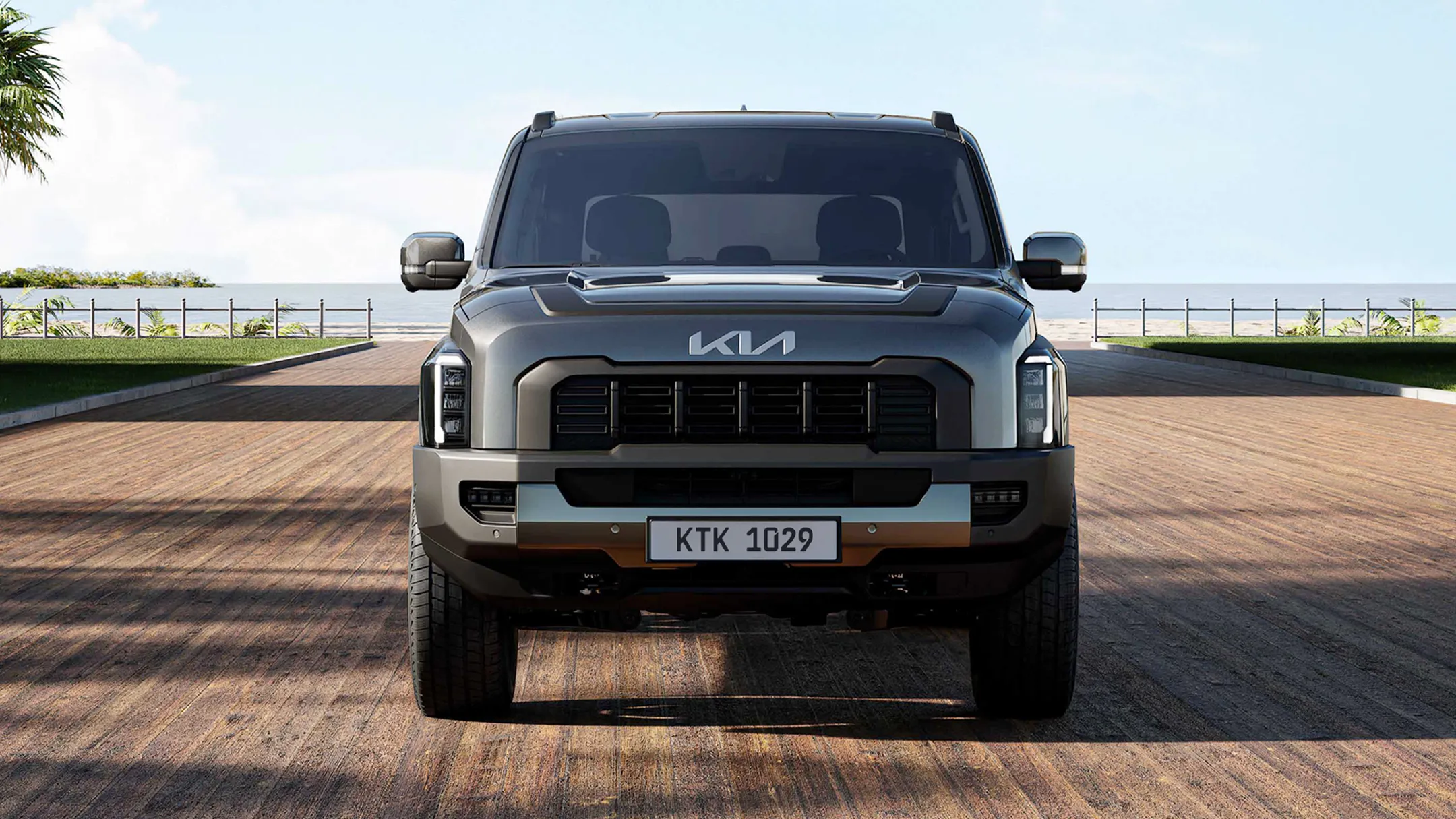 정면에서 바라본 사막 배경 위의 기아 타스만 픽업트럭 모습