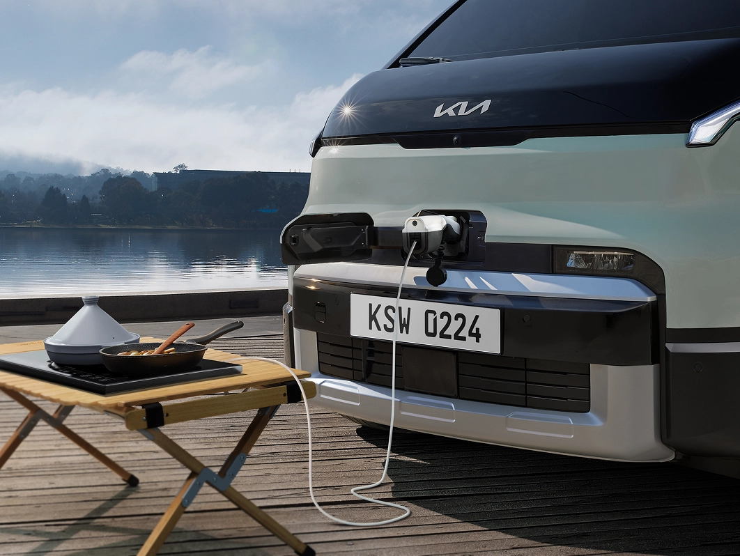 Front view image of Kia PV5 charging outdoors