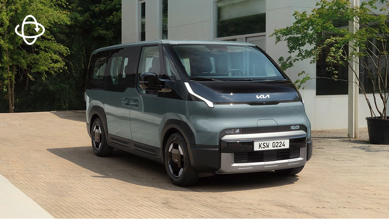 Side view image of Kia PV5 Passenger parked in front of a building
