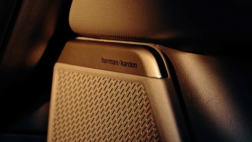 A driver pressing the Drive Mode button on the steering wheel.