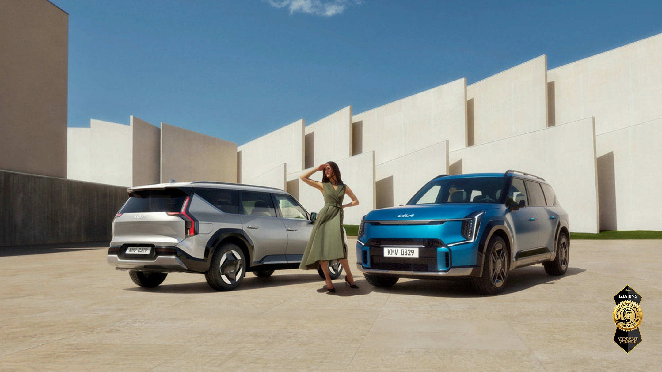 Image of two Kia EV9 vehicles parked in front of a modern building, winner of the 2024 Women’s Worldwide Car of the Year